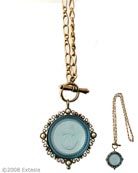 From our Victoriana Collection, in new Aqua German glass intaglio. Shown in classic setting on a simple chain necklace. Large pendant is just under 2 inches in diameter. Chain necklace is 28 inches in length. Shown in our signature bronze metal. Hand made to order in the USA.