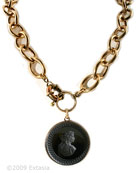 From our Oak & Stag Collection. Small oak/acorn motif on the metal sides of pendant, shown in classic opaque Jet. Opaque jet German Glass intaglio features a woman from antiquity looking back over her shoulder. Modern and Vintage create a fresh look with this bold bronze chain. Each chain link measures 3/4 inch in length. Large pendant measures 1 1/2 inches in diameter. 21 inch necklace length. This is a large statement necklace. Shown in our signature bronze, also available in Silver Plate by request.