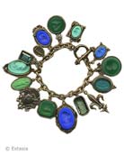 Our over the top charm bracelet. Shown here in a mix of blues and greens. 15 hand pressed German glass cameos and intaglios and cameos. Measures almost 8 inches in length. Largest charm is 1 1/4 by 7/8 inch. Bronze, each bracelet made to order in the USA from the worlds finest materials.